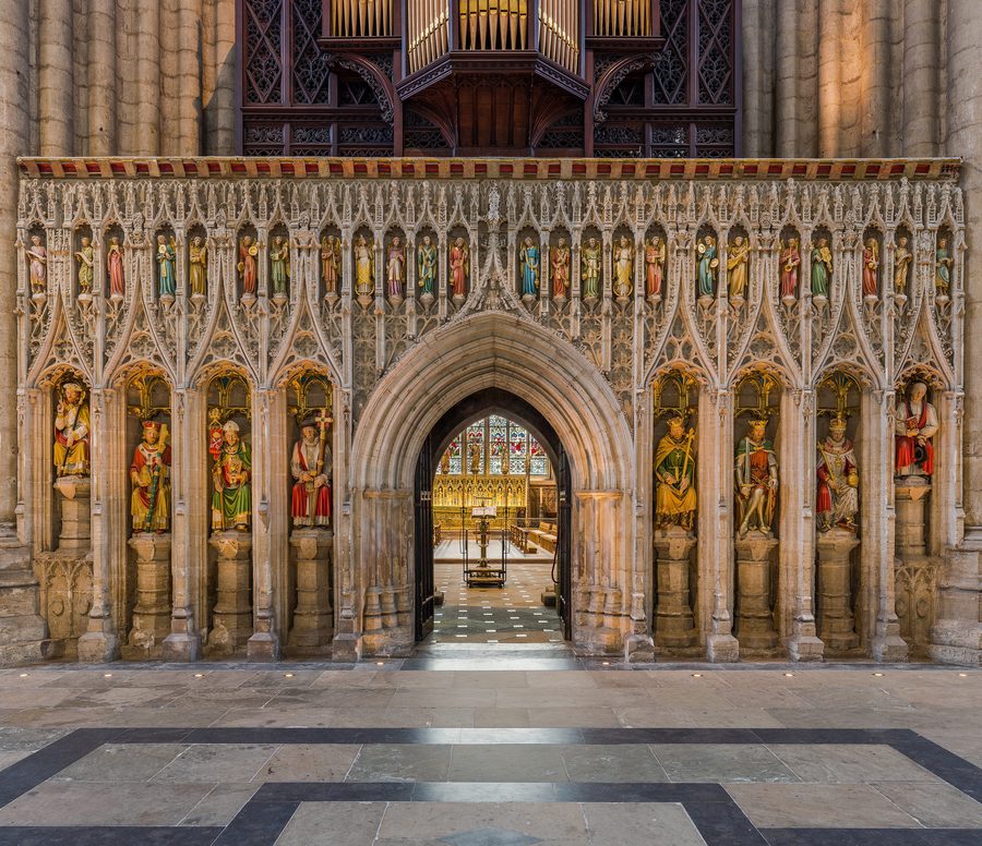 The carved stone pulpitum of Ripon Cathedral with rows of statues and the organ above