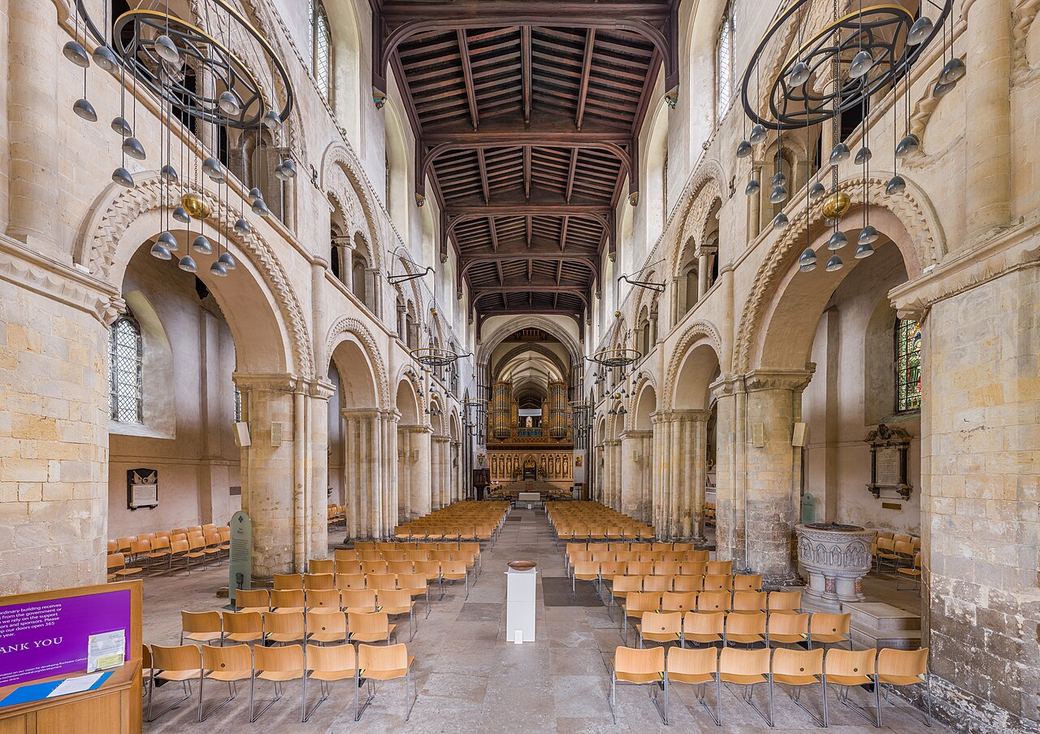 The Norman nave of Rochester Cathedral with round arches and a flat timber ceiling