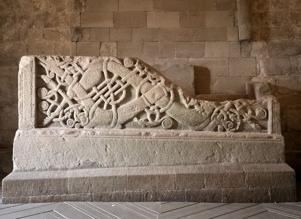 The carved Romanesque sarcophagus in Cormac's Chapel, with interlaced beasts and snakes