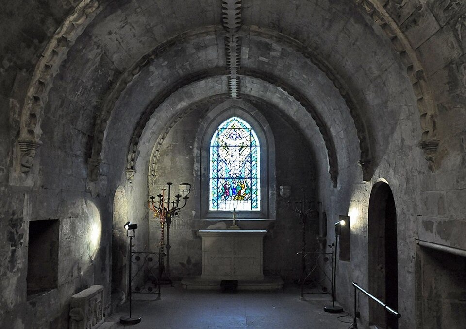 The vaulted sacristy or crypt beneath Rosslyn Chapel with a stained glass window