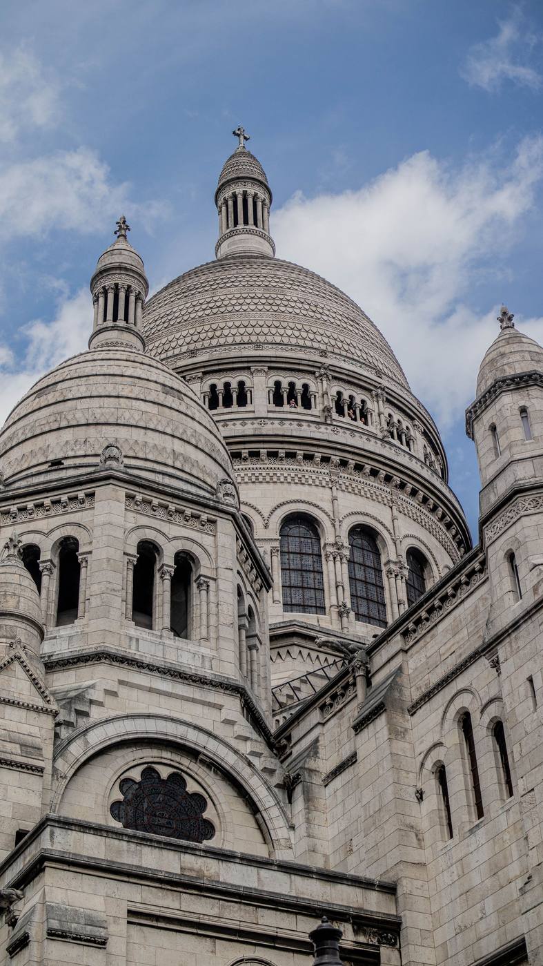 The domes and small towers of Sacré-Cœur seen from close below