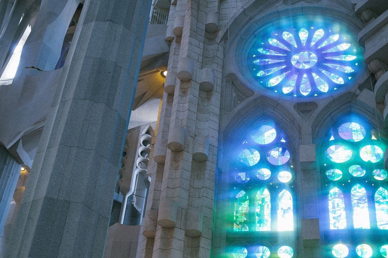 Blue and green light from stained glass windows inside the Sagrada Familia