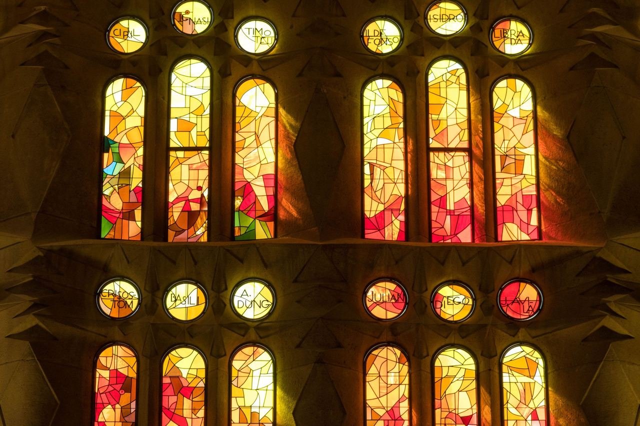Red and orange light from stained glass windows inside the Sagrada Familia