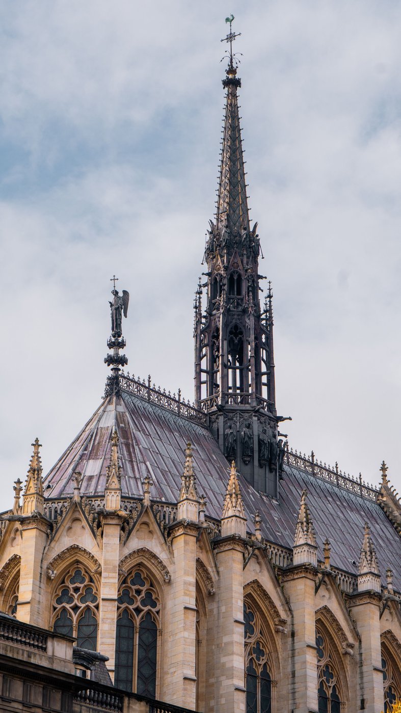 The slender spire and steep roof of the Sainte-Chapelle rising above the Palais de Justice