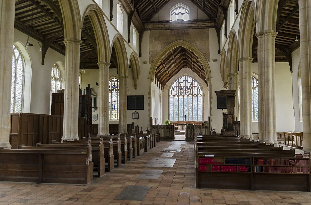 The long, light nave of Salle church with tall arcades, clear glass and a timber angel roof