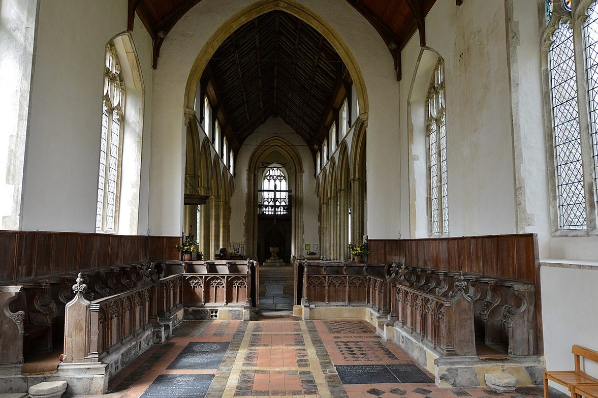 The medieval choir stalls of Salle church, looking west down the long nave