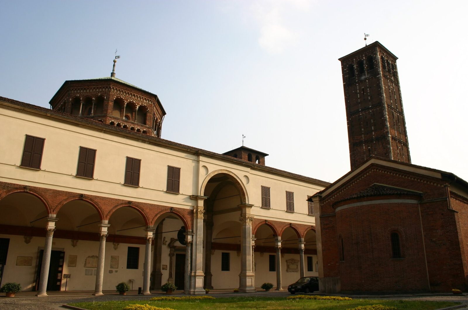 Bramante's arcaded portico of the canonry beside Sant'Ambrogio, with the brick bell tower behind