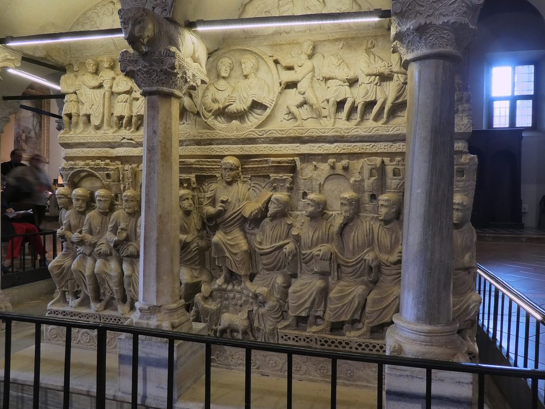 The carved late Roman sarcophagus known as Stilicho's, with the Romanesque pulpit above it, in the nave of Sant'Ambrogio