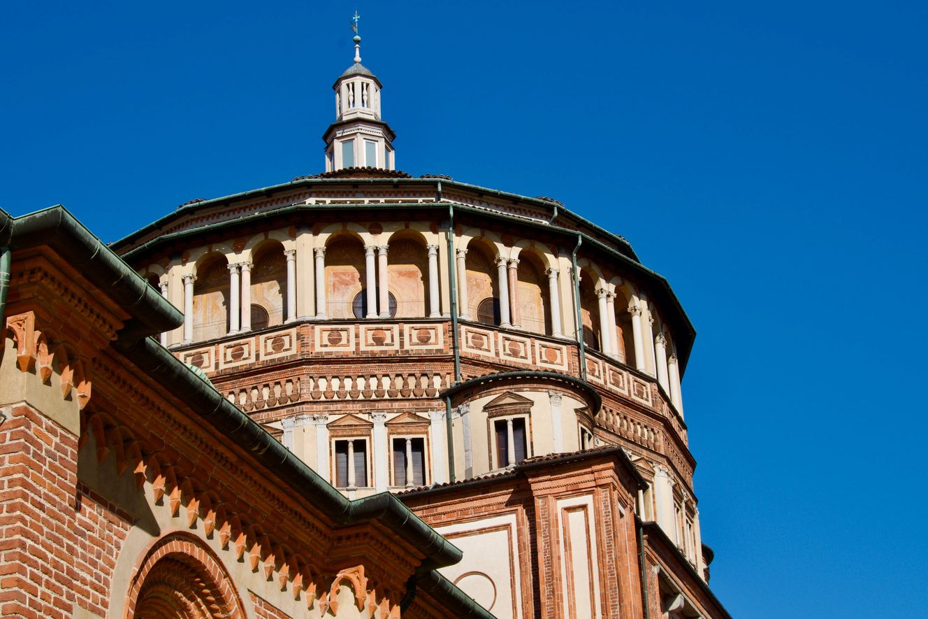 The sixteen-sided drum and dome of Bramante's tribune at Santa Maria delle Grazie against a blue sky