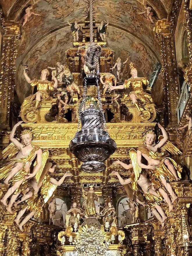 The silver Botafumeiro hanging in front of the high altar of Santiago de Compostela Cathedral