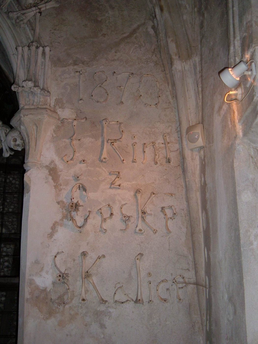 Frantisek Rint's signature spelled out in human bones on the wall of the ossuary