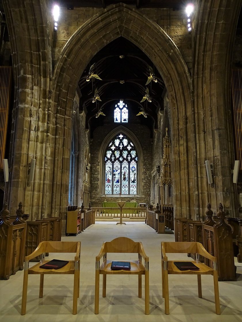 Looking east into the medieval chancel of Sheffield Cathedral, under its dark timber roof, to the east window