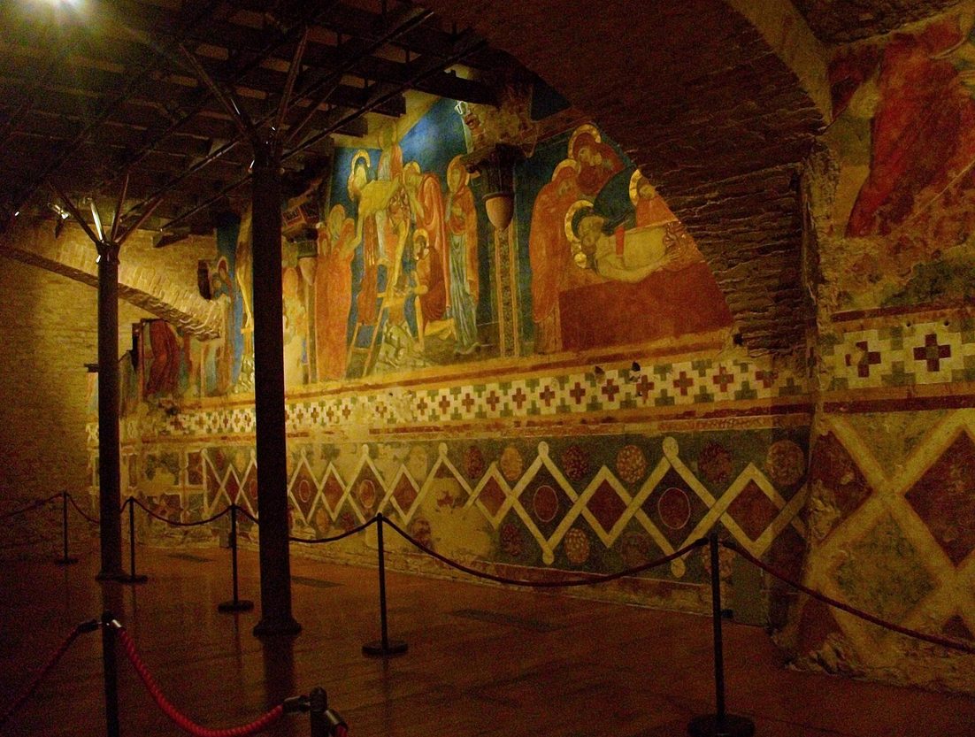 Thirteenth-century wall paintings in bright reds and blues in the crypt beneath Siena Cathedral