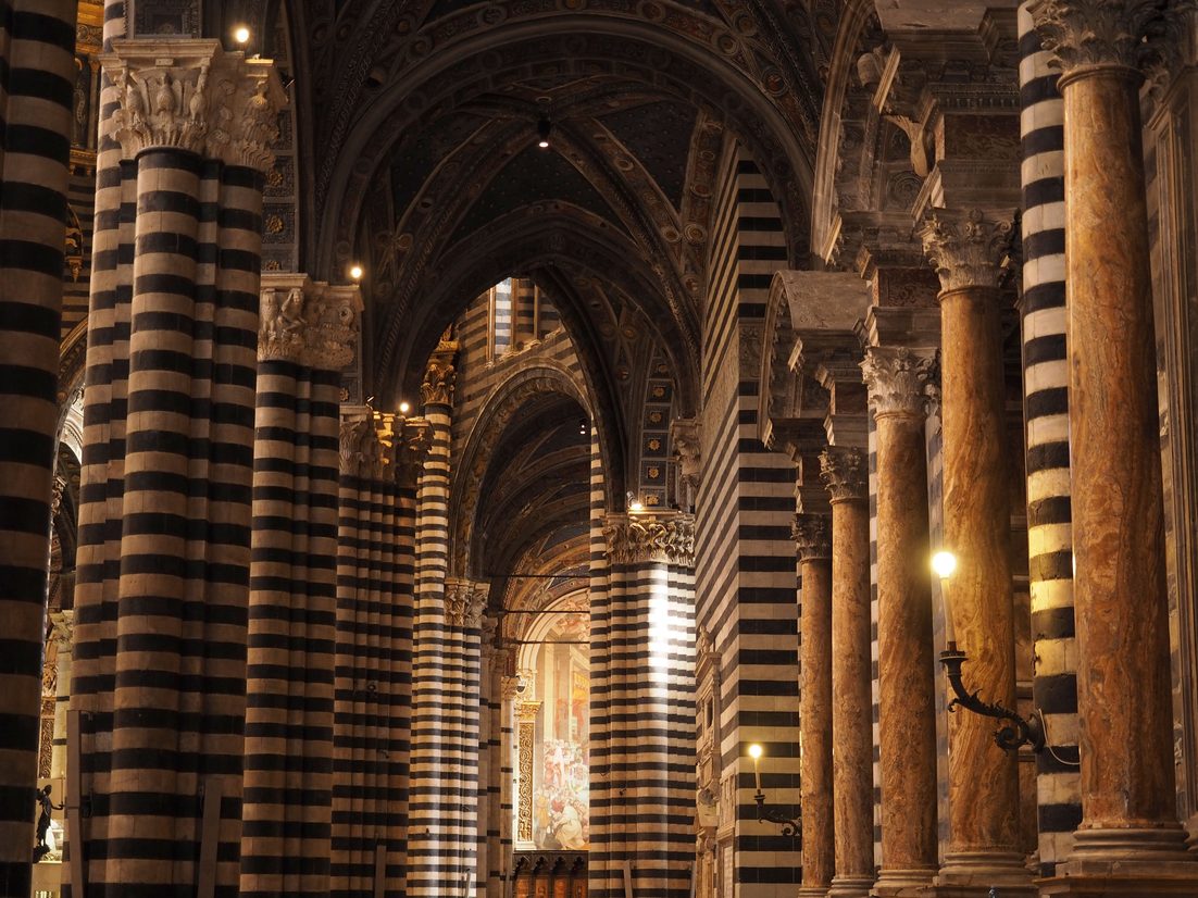 Black and white striped marble columns in the nave of Siena Cathedral