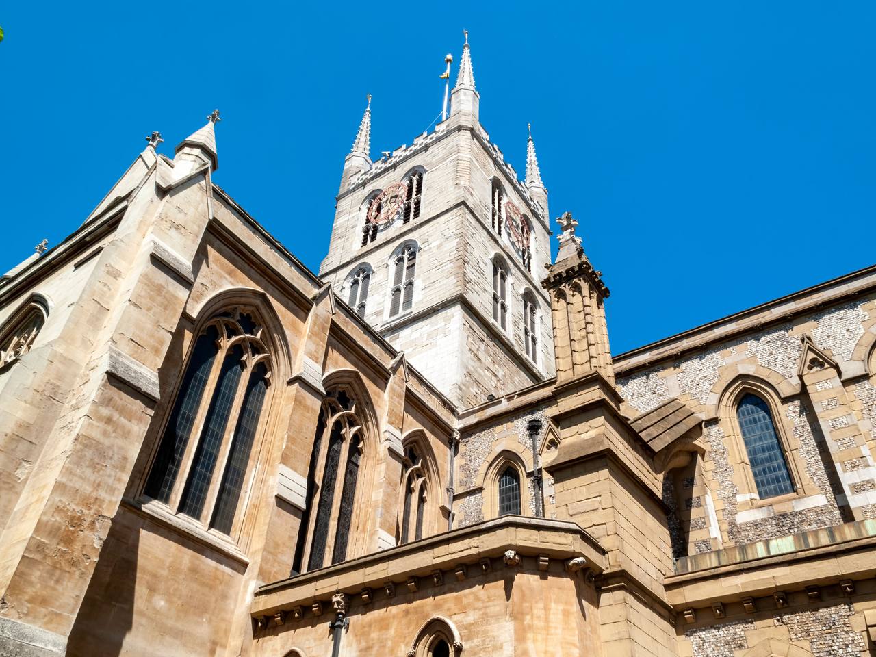 The square pinnacled tower of Southwark Cathedral above the transept, seen from below