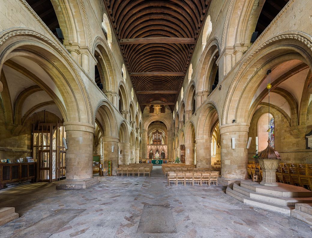 The Norman nave of Southwell Minster with massive round pillars and arches under a timber roof