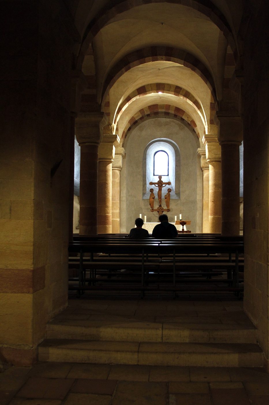 The vaulted Romanesque crypt of Speyer Cathedral with its sandstone arches and a small altar