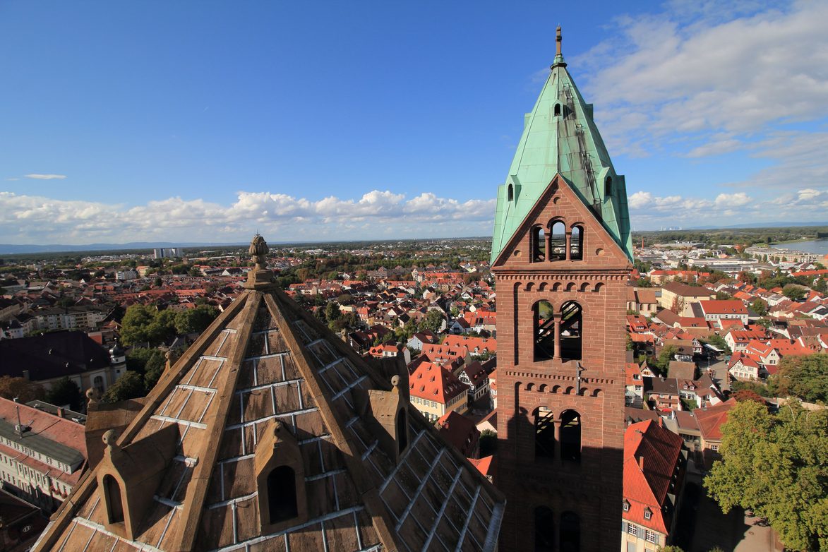 The view from the tower of Speyer Cathedral over the roof, a green-capped tower and the city