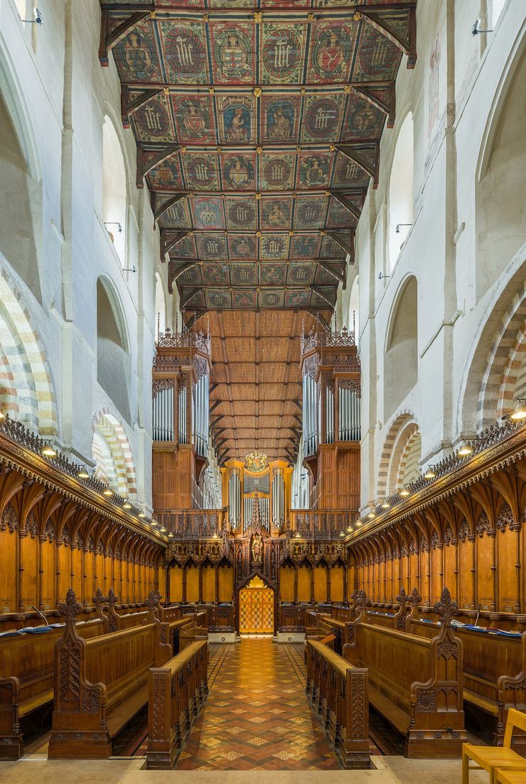 The choir of St Albans Cathedral with its painted wooden ceiling and the great screen beyond