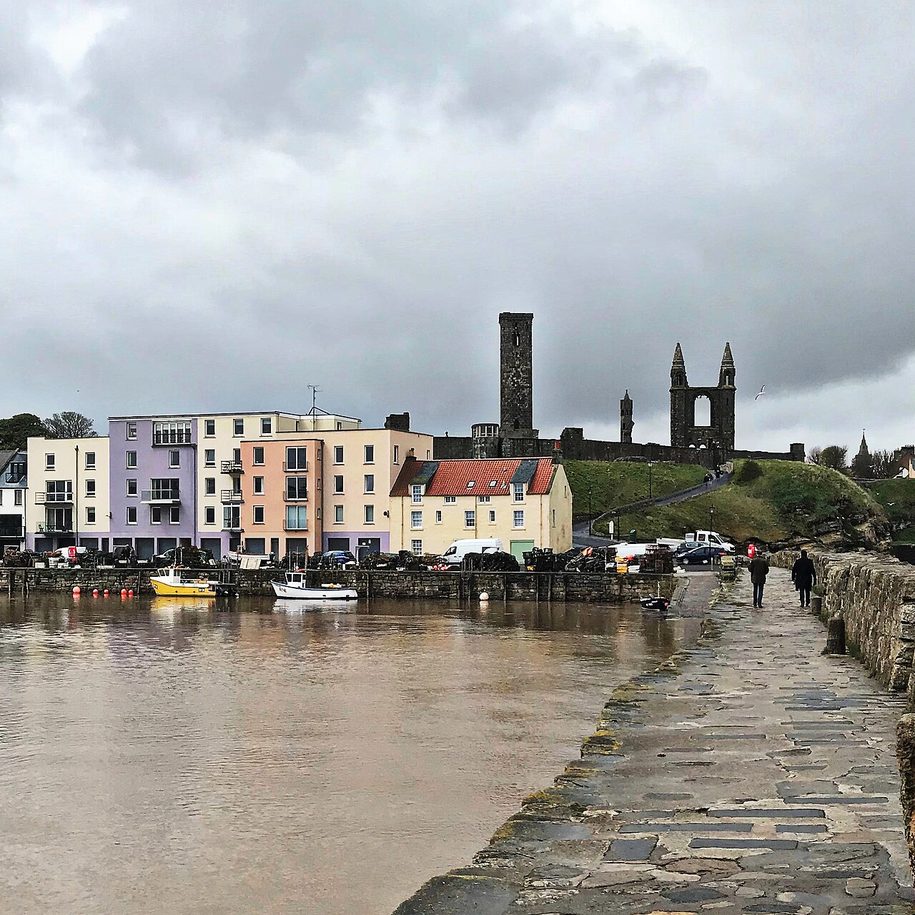 The towers of St Andrews Cathedral seen above the harbour from the pier