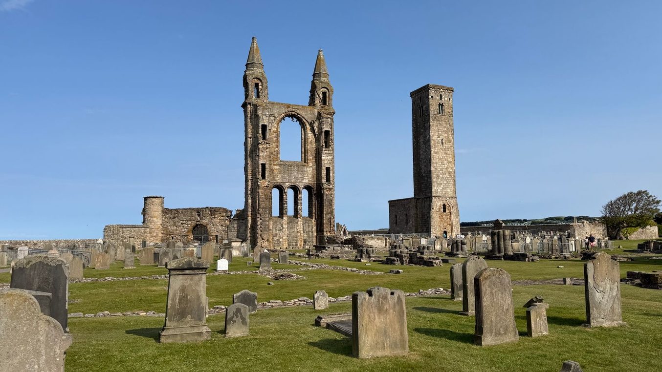 The ruined east gable of St Andrews Cathedral and the square St Rule's Tower rising above the gravestones, Fife