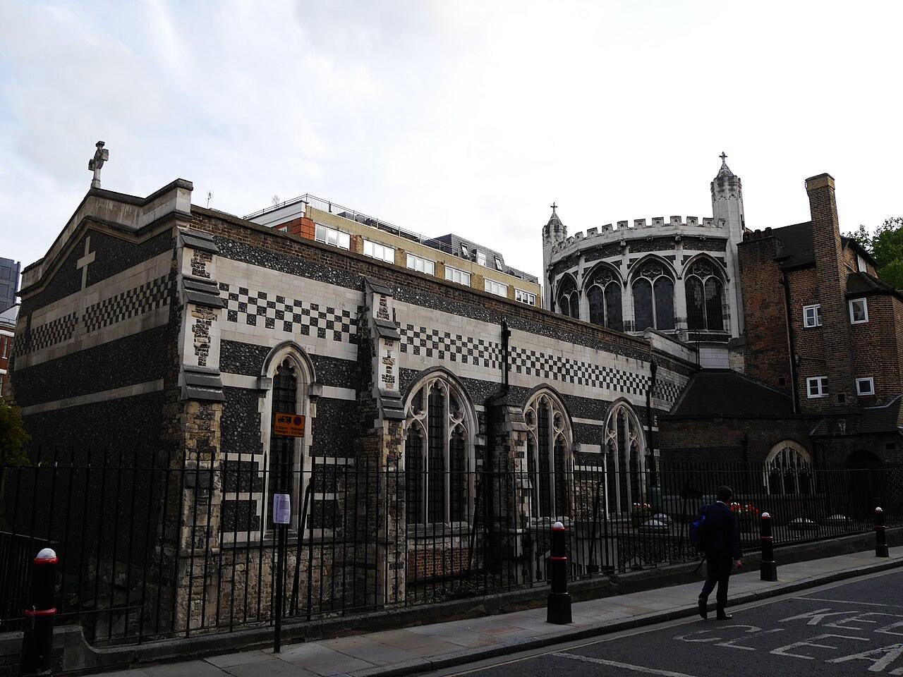 The flint and stone exterior of St Bartholomew the Great beside Cloth Fair in the City of London