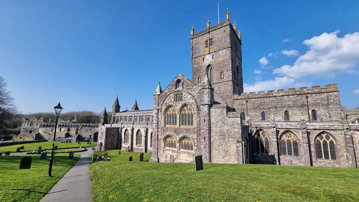 The west front of St Davids Cathedral with its rows of round arches and the central tower behind