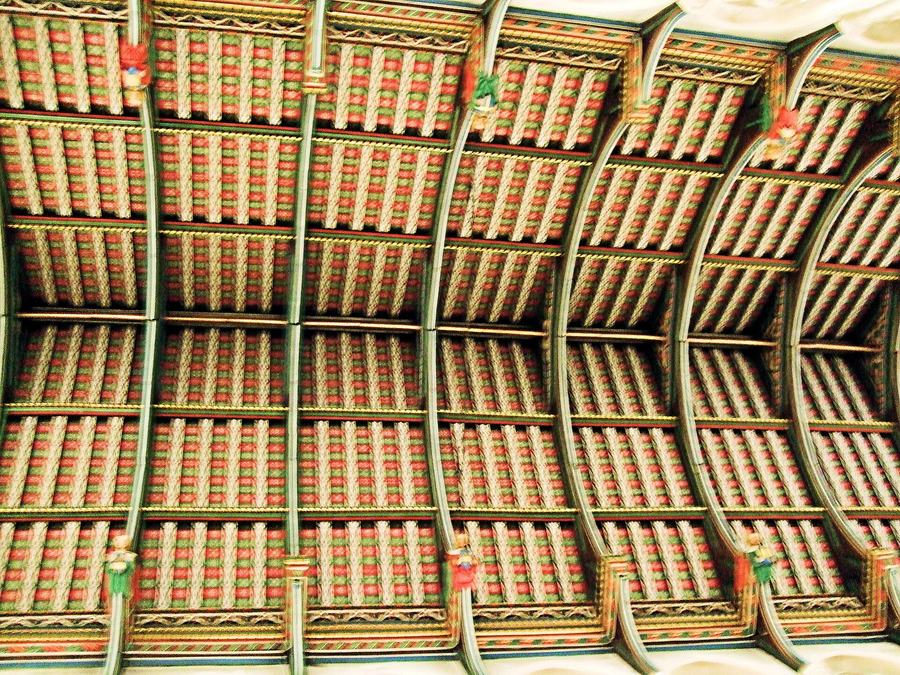 The brightly painted timber hammerbeam roof of the nave of St Edmundsbury Cathedral