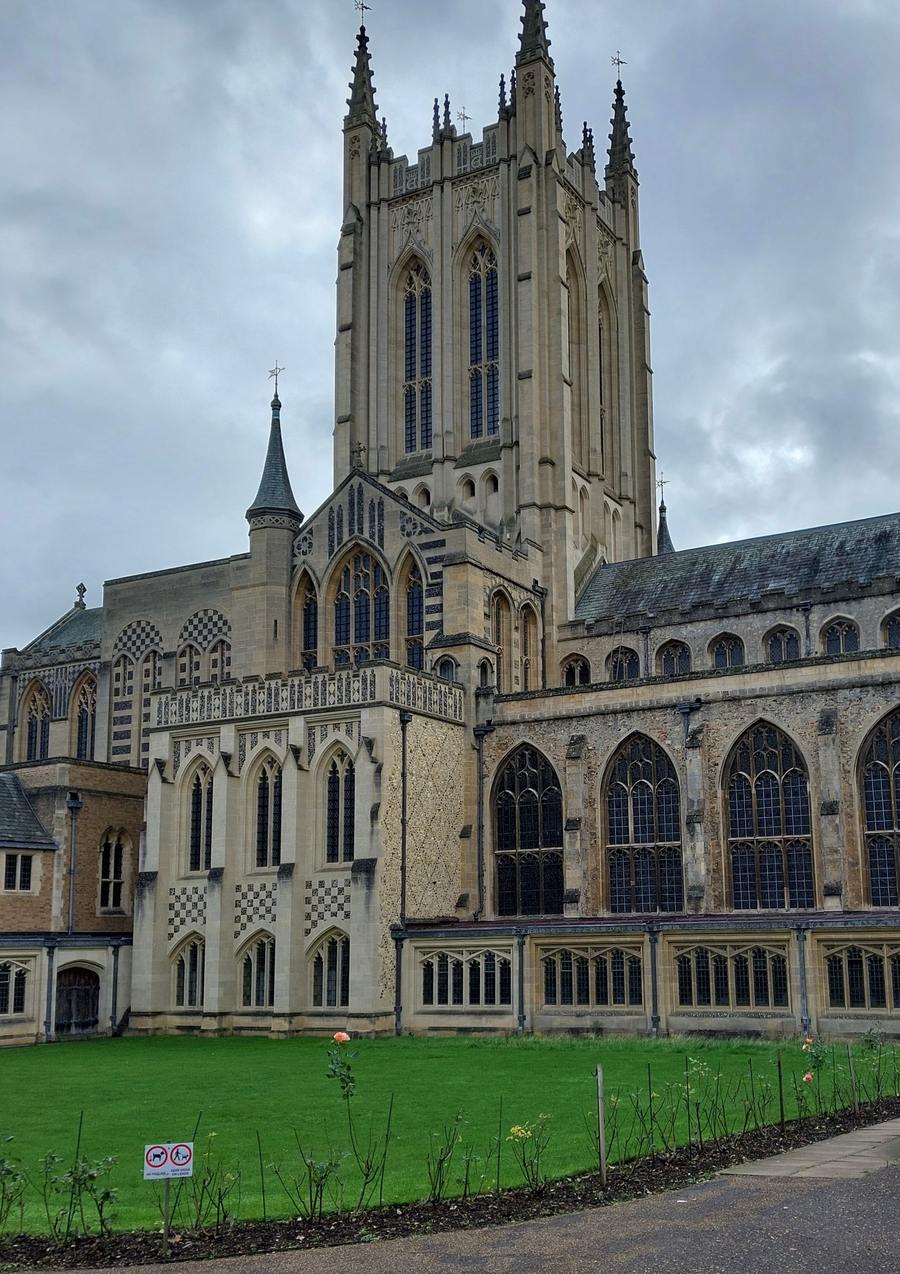 The tall pinnacled Gothic Revival tower of St Edmundsbury Cathedral above the cathedral roofs