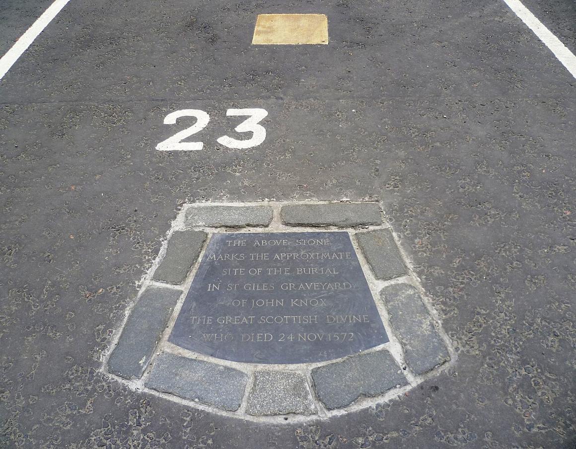 The marker of John Knox's grave in parking space 23 in Parliament Square