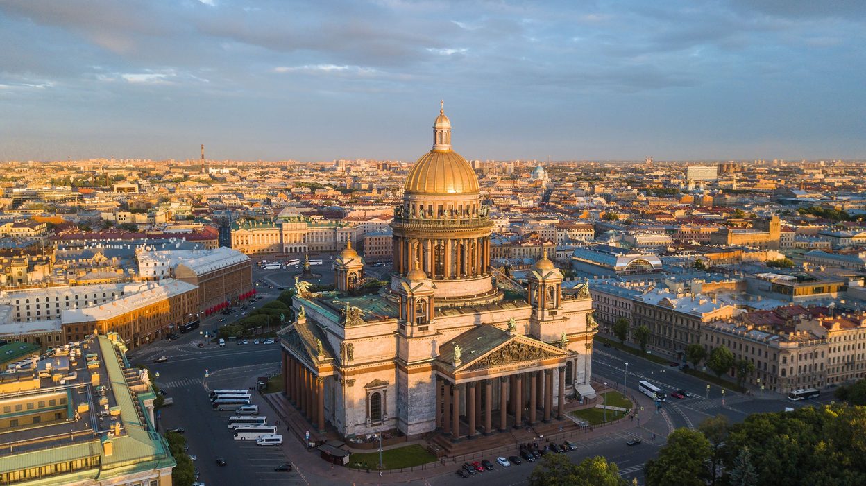 Aerial view of St Isaac's Cathedral and its square in the evening light, with the city stretching beyond