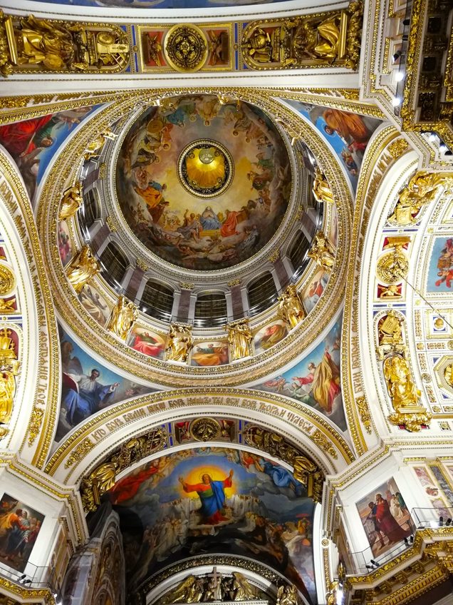 Looking up into the painted inner dome of St Isaac's Cathedral, with the dove of the Holy Spirit at its centre