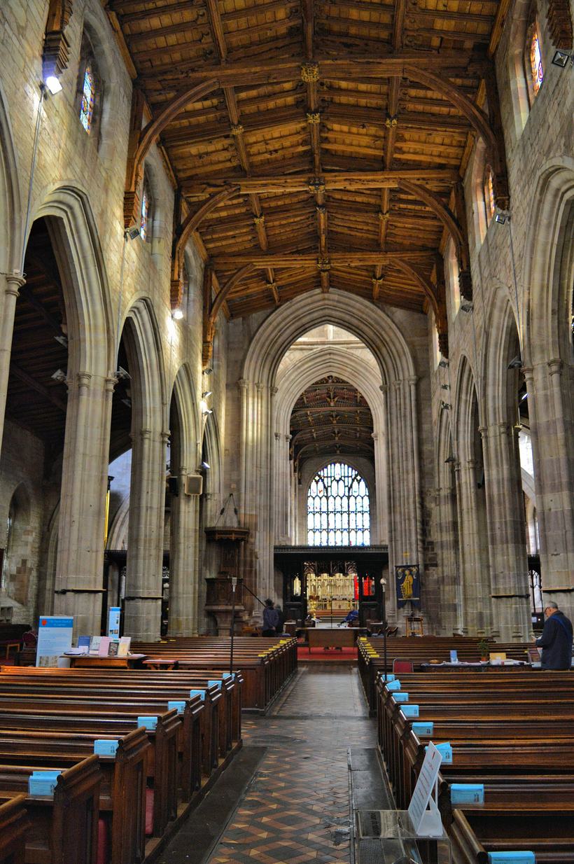The long nave of St Laurence's Church in Ludlow looking east through the crossing