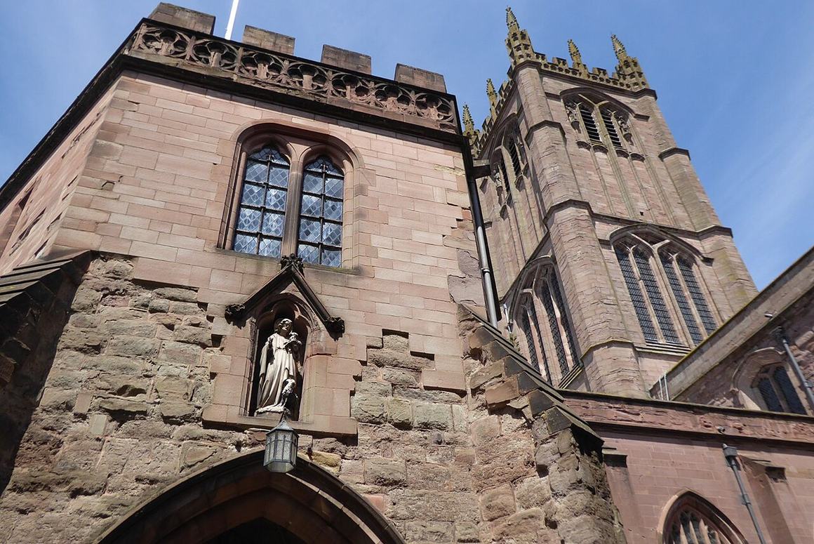 The six-sided south porch of St Laurence's Church in Ludlow, with a statue in a niche, and the tower behind