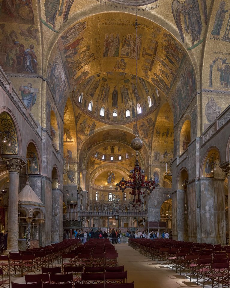 The interior of St Mark's Basilica, with gold mosaic domes and a great hanging lamp