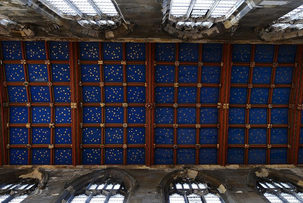 Looking up at a painted panelled timber ceiling of deep blue with gold stars at St Mary's, Beverley