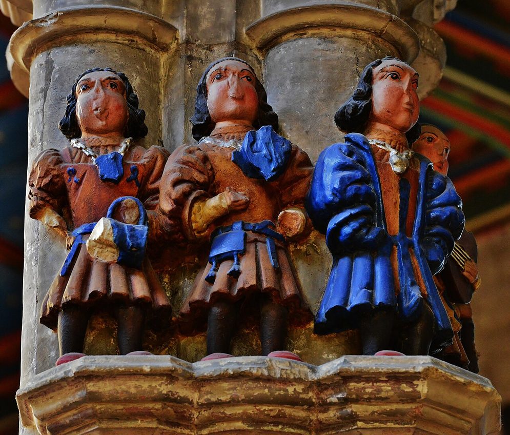 Painted carved figures of medieval minstrels on top of a pillar in St Mary's Church, Beverley