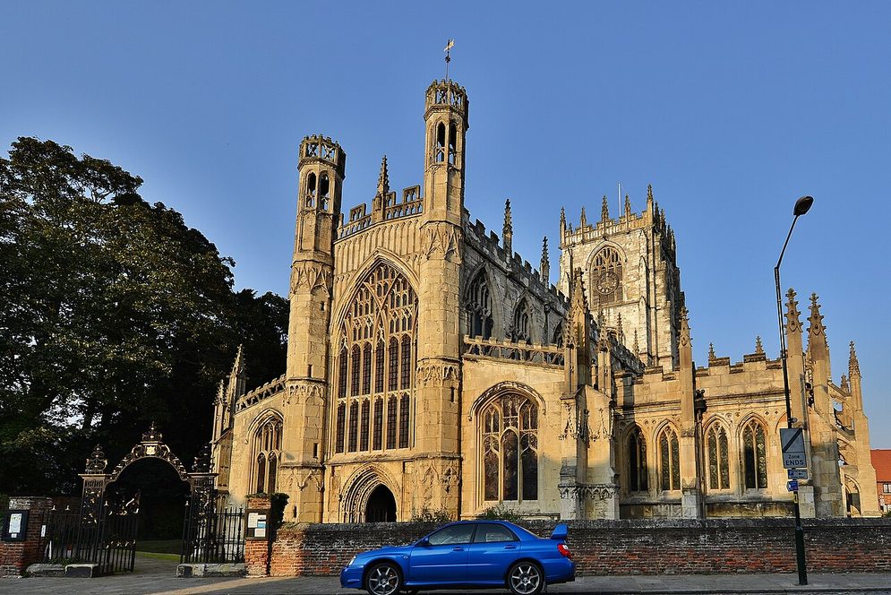 The pinnacled west front of St Mary's Church, Beverley, glowing gold in evening light