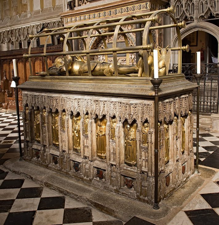 The gilt bronze effigy of Richard Beauchamp, Earl of Warwick, lying on his tomb chest under a hooped bronze hearse