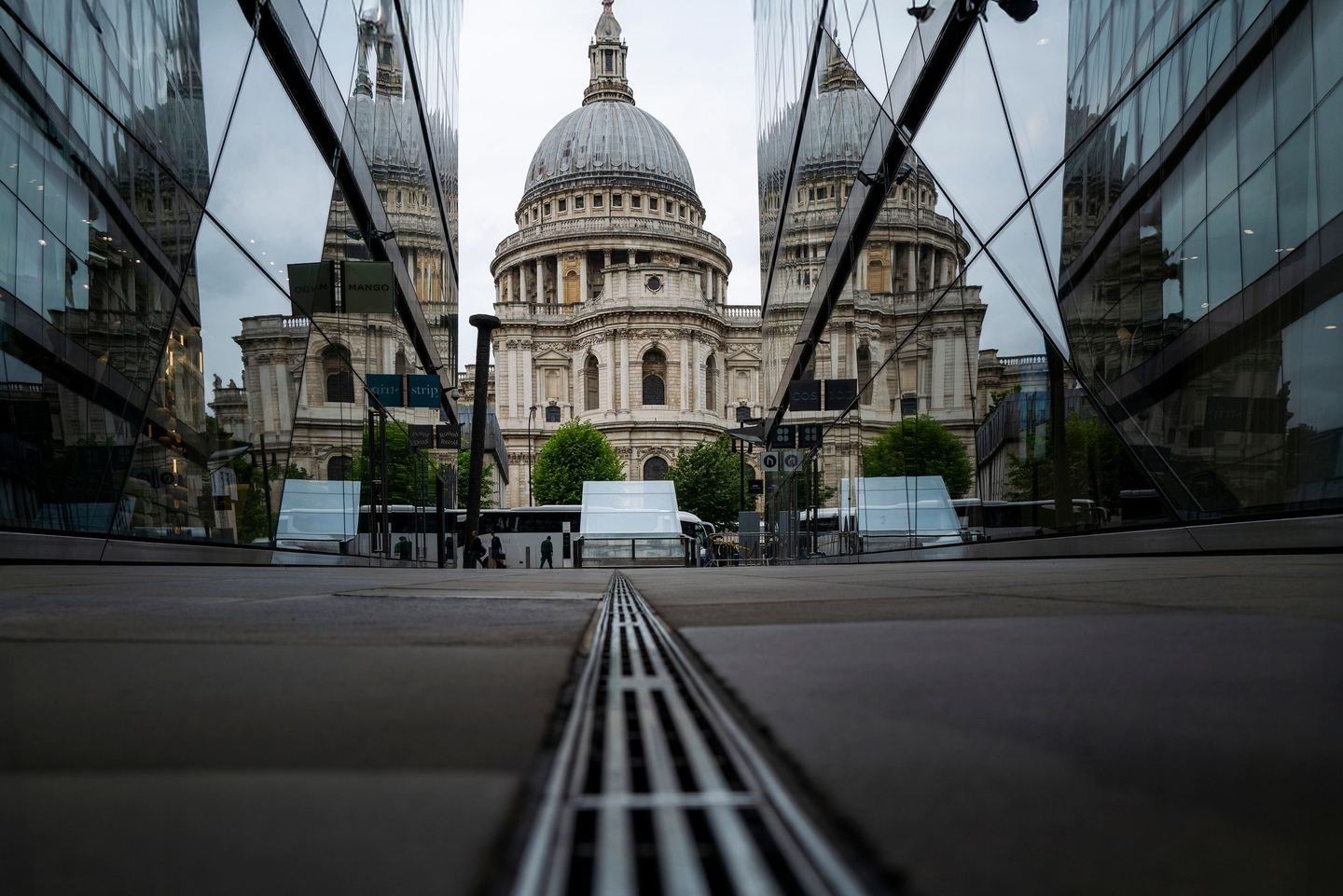 St Paul's Cathedral reflected in the glass of a modern office building