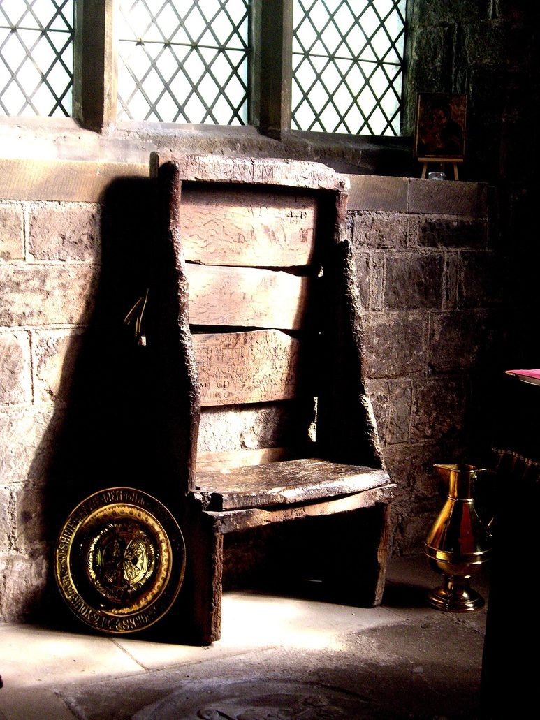Bede's Chair, a battered old wooden chair standing by a window in St Paul's Church, Jarrow