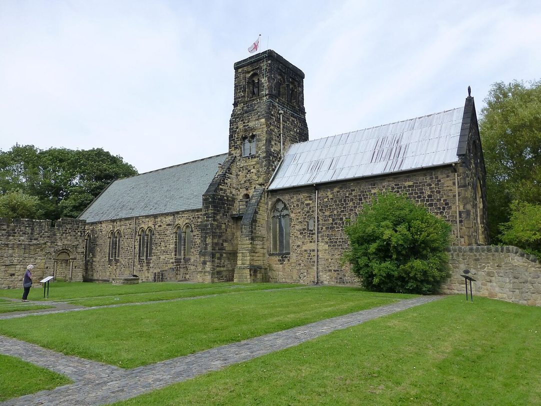 St Paul's Church, Jarrow, behind the low stone walls of the ruined monastery buildings in the grass