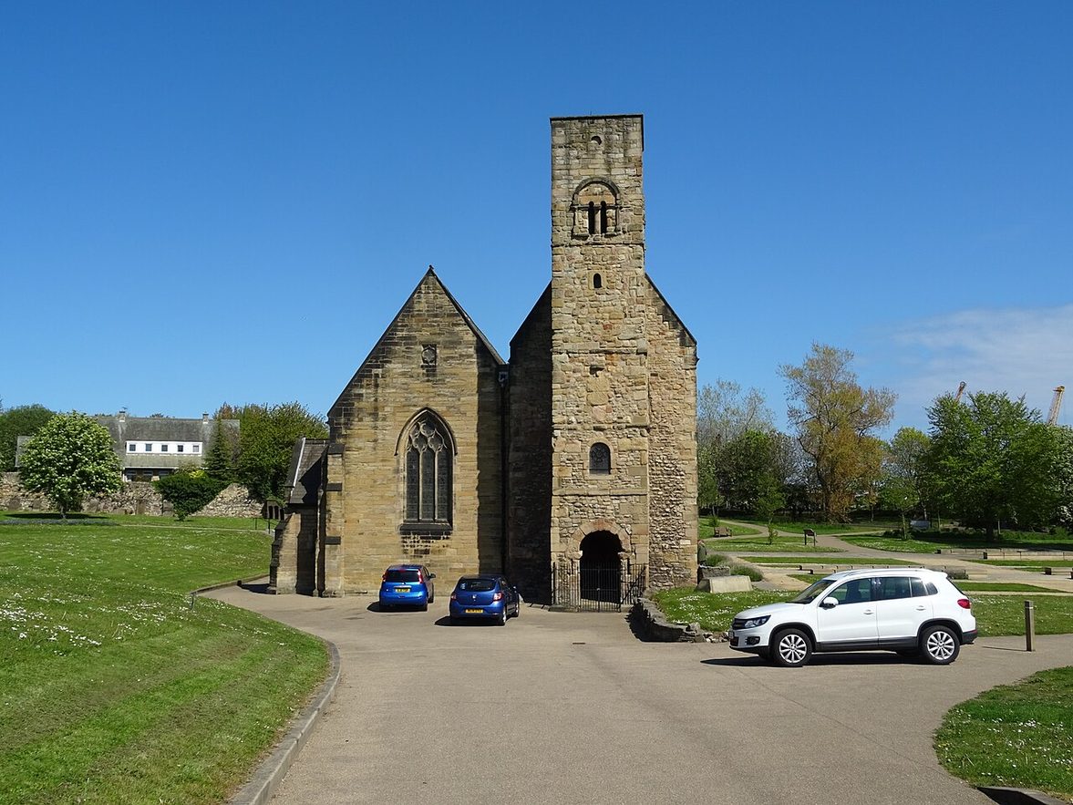 The west end of St Peter's Church, Monkwearmouth, with its tall narrow Anglo-Saxon tower and porch beside the gable of the nave