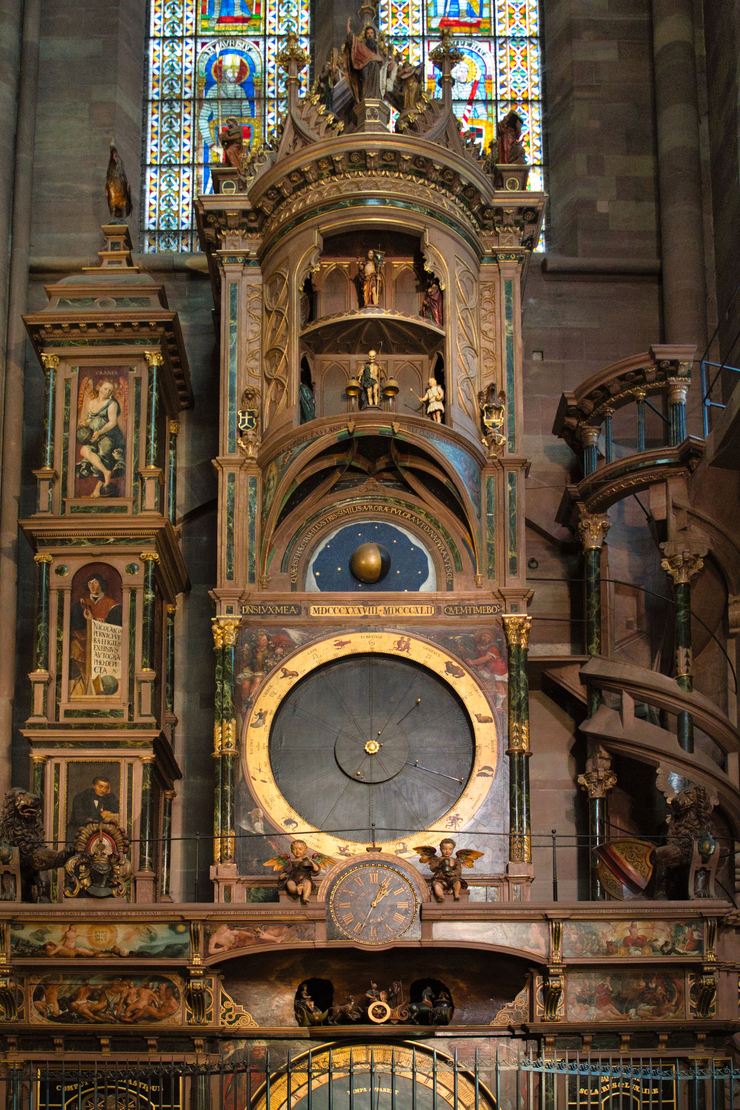 The astronomical clock in Strasbourg Cathedral, a tall painted and gilded case with dials and automata