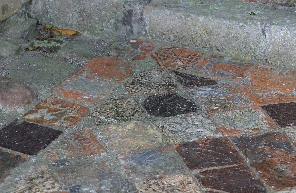 Medieval glazed floor tiles with patterned designs in one of the chapels of Strata Florida Abbey