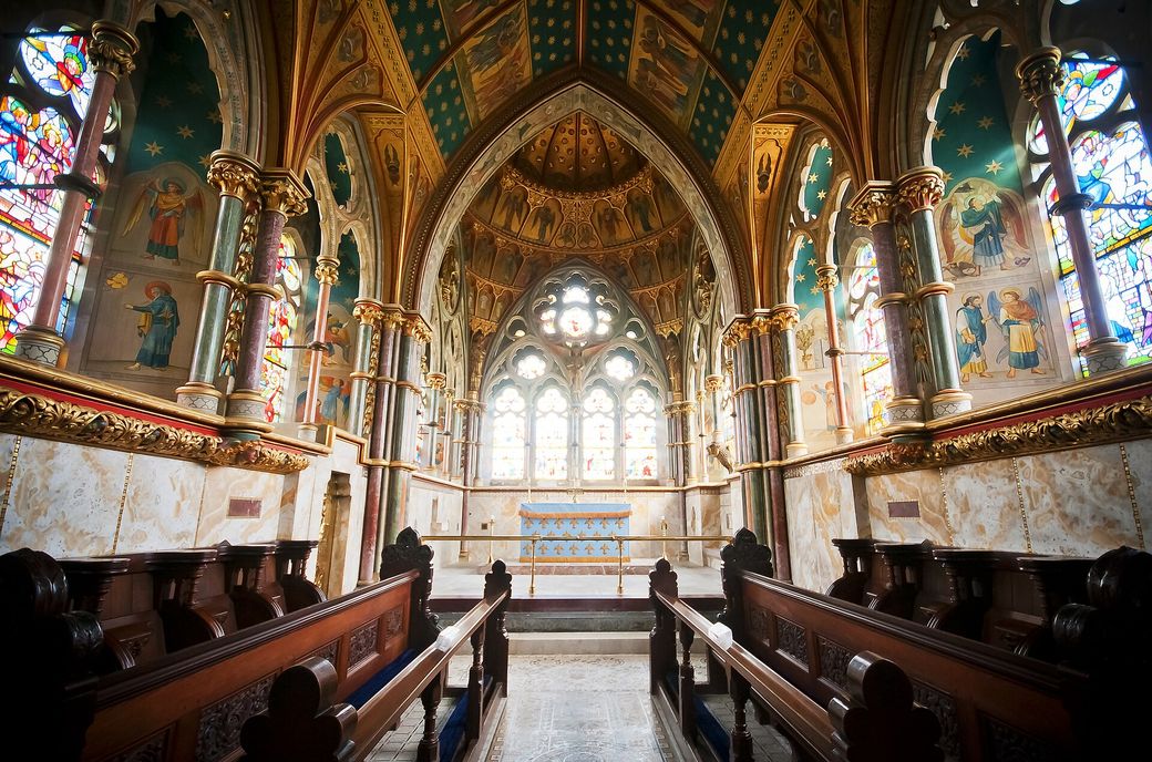 The richly painted and gilded chancel of St Mary's Church, Studley Royal, with stained glass and marble