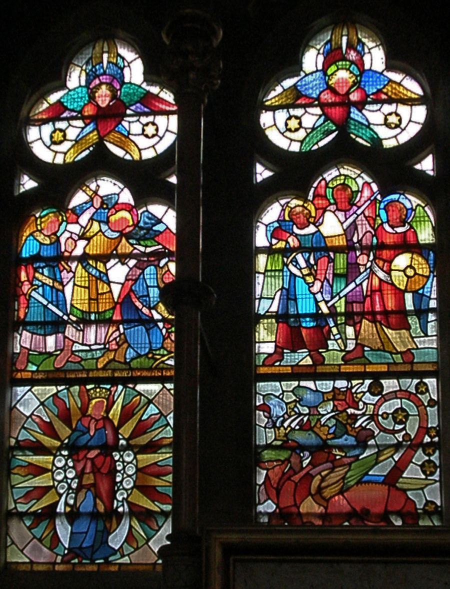 Two stained-glass lights at St Mary's, Studley Royal, with angels fighting a red dragon and the woman clothed with the sun