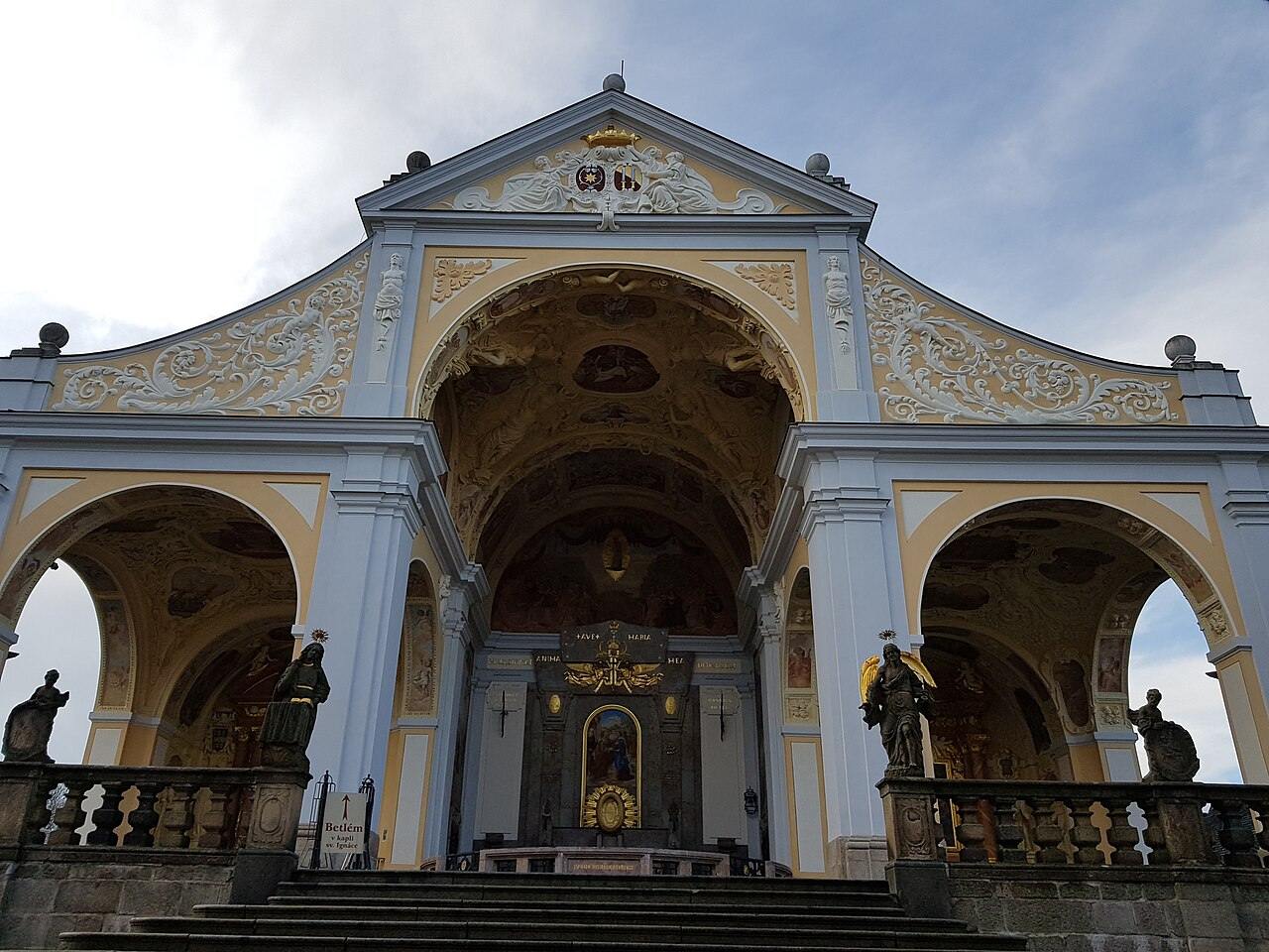 The arcaded east front of the Svatá Hora basilica with statues on the balustrade