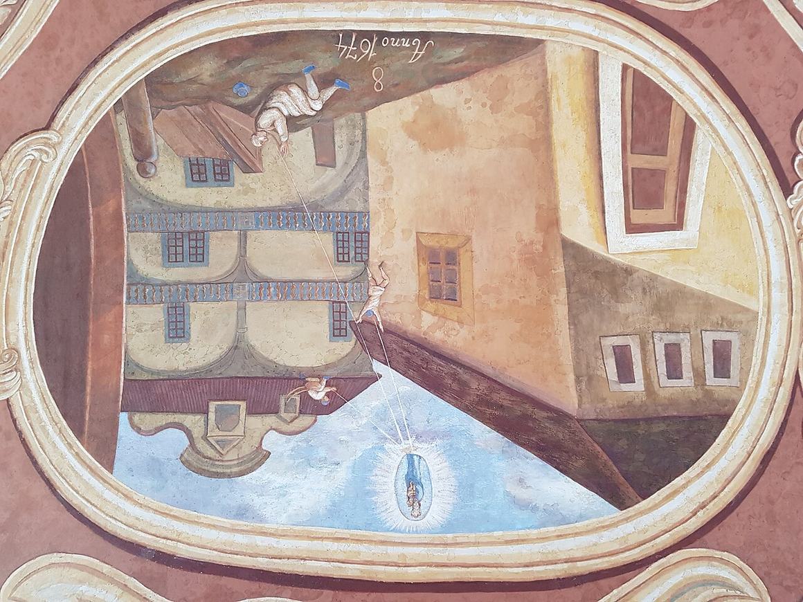 A painted lunette in the Svatá Hora cloister showing pilgrims before the shrine