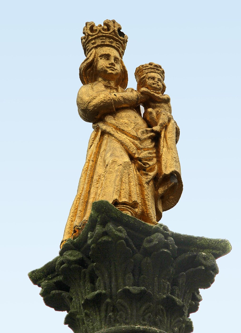 A gilded crowned statue of the Virgin and Child on top of a column at Svatá Hora
